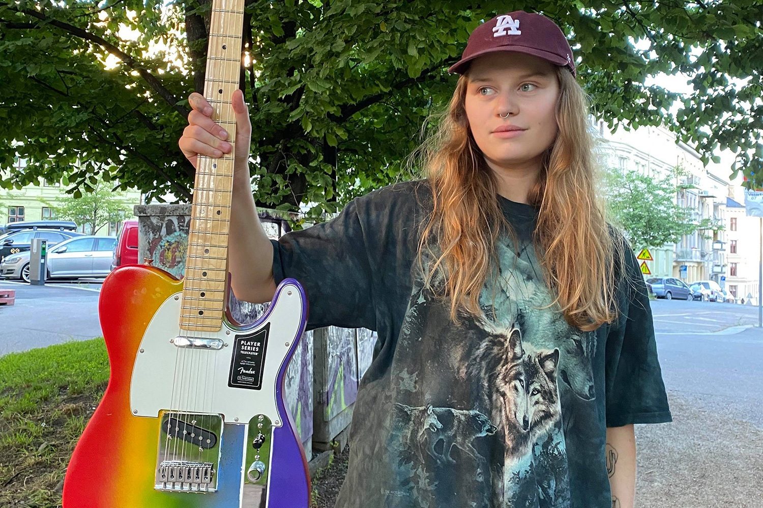 girl in red has designed a one-of-a-kind rainbow guitar to be raffled off for the Kaleidoscope Trust