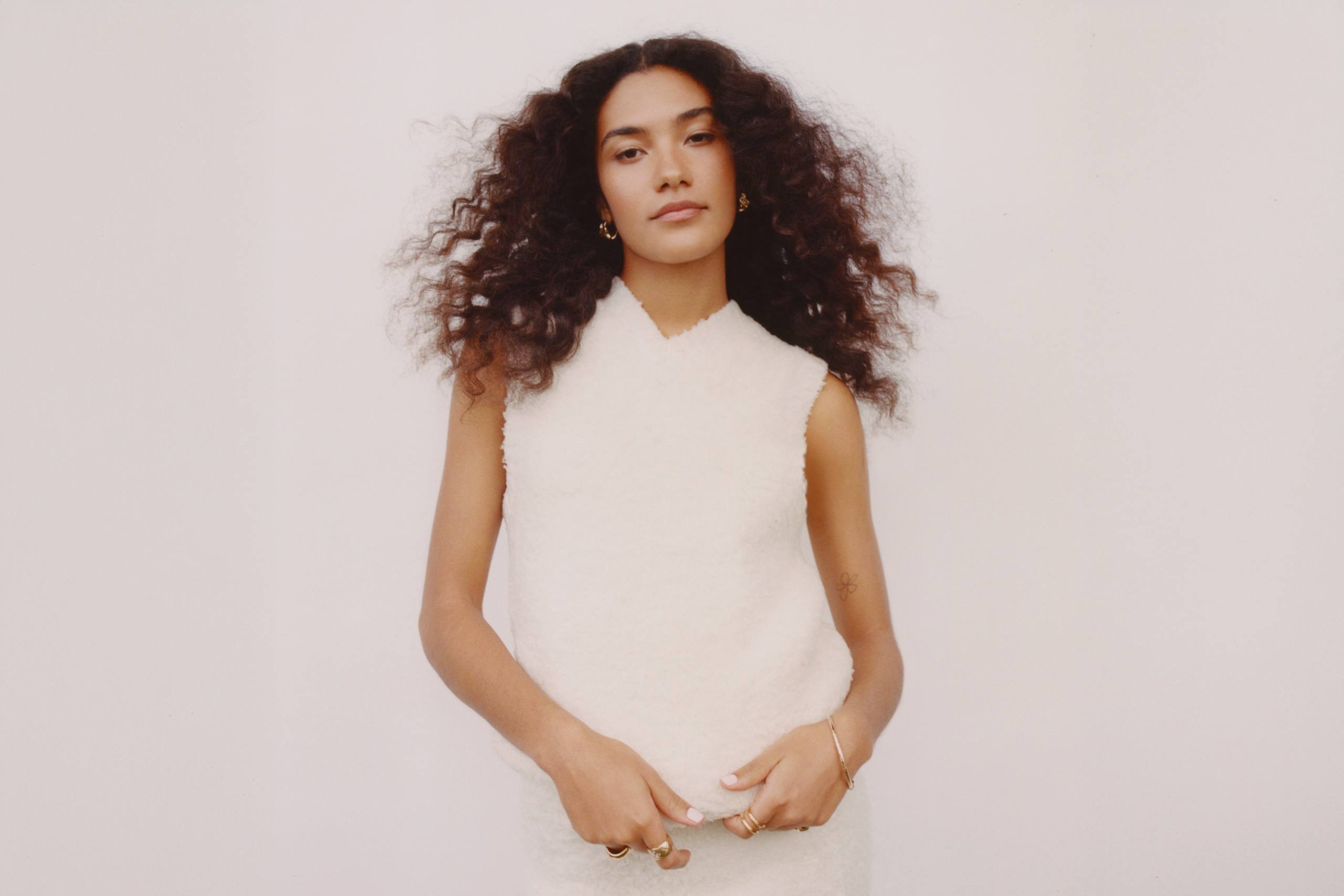 Olivia Dean goes plane spotting in her new video for recent single 'Time'